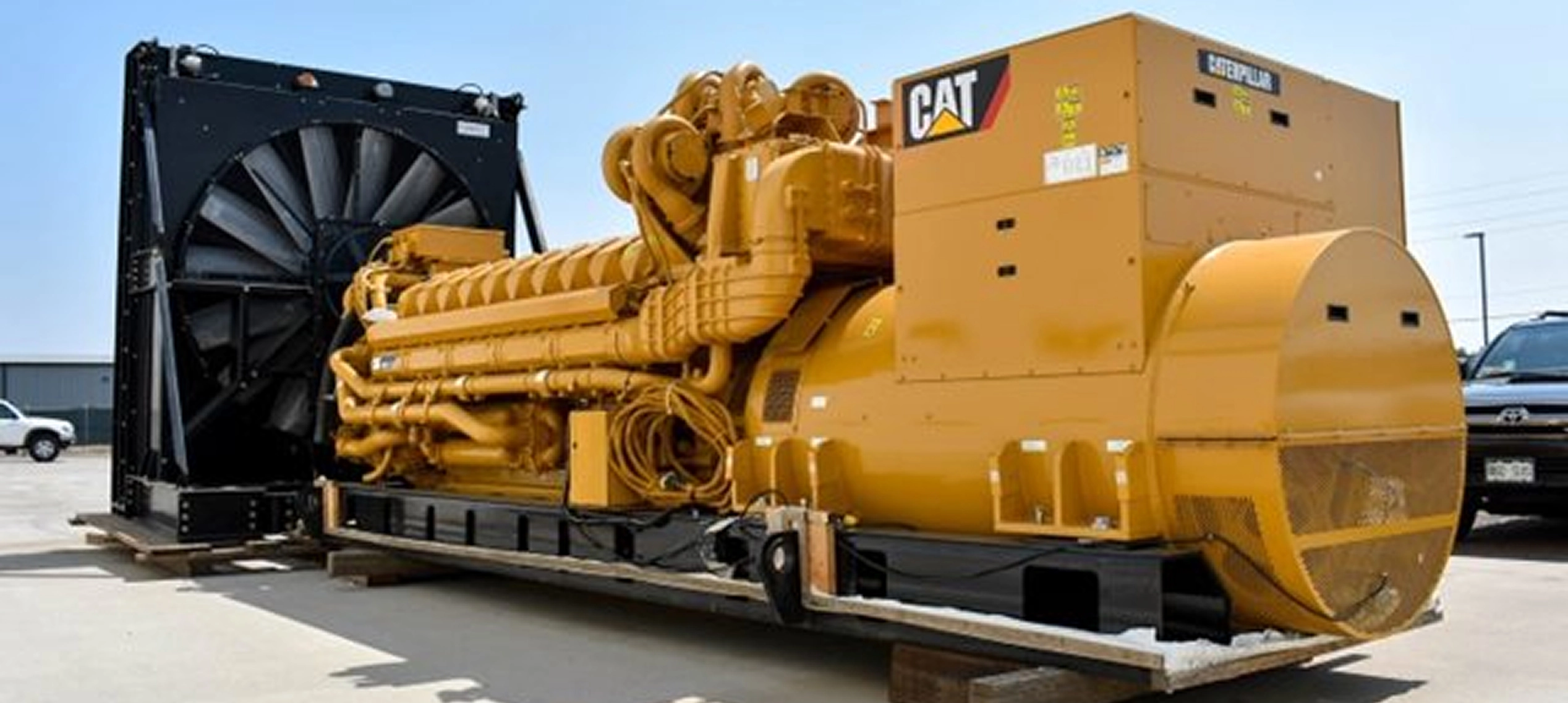Giant CAT engine with a cooling fan ready to be loaded and shipped.