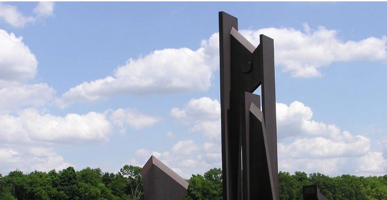 A large, vertical sculpture fabricated from metal