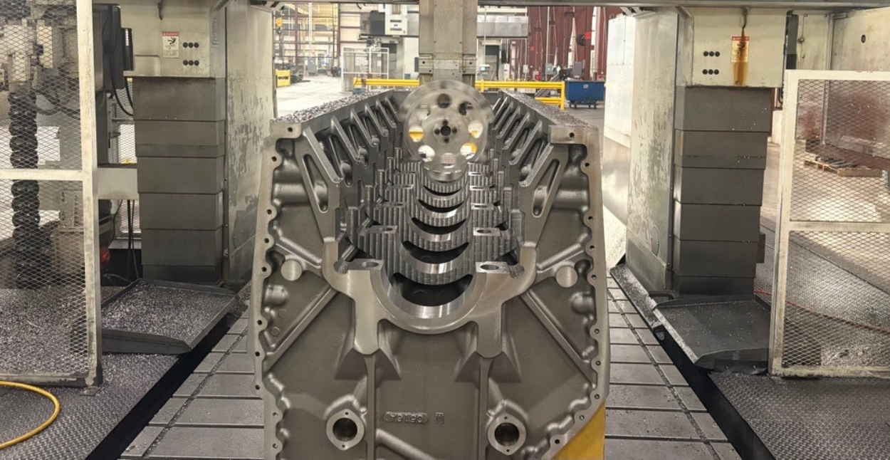 A view inside a CNC machine as it is drilling holes into a part that is chucked in a machine spindle